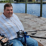  video of executive director Mark  Felling demonstrating Hands-on Adjustable, Hinged Fish Fighting Rod Holder for Wheelchair Seat  on dock in Florida with adaptive fishing electric reel mounted